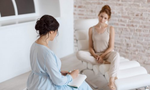 Psychologist having session with her patient in office